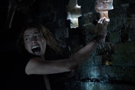 Film still showing Scodelario screaming while grabbing on to a wall.