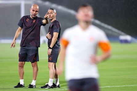 Manchester City manager Pep Guardiola speaks with his assistant Carlos Vicens during a training session before the 2023 Fifa Club World Cup final against Fluminense.