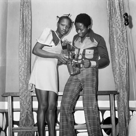 Funmilayo and John Abe holding their medium-format camera at their studio on Aina Street in Lagos.