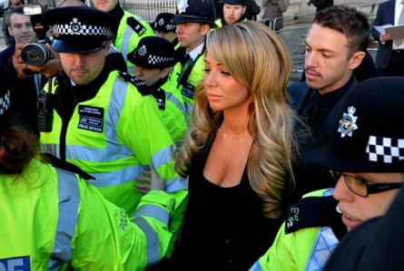 Tulisa surrounded by police as she leaves court.