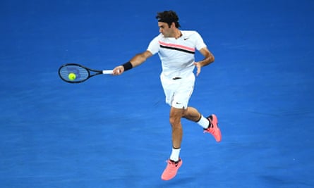 Roger Federer wears a Nike T-shirt that matches his pink sneakers in 2018.