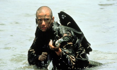 Demi Moore in Ridley Scott’s GI Jane, holding a gun in the sea