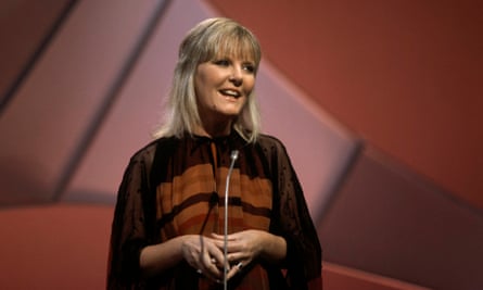 Petula Clark in front of a microphone wearing a stripy top