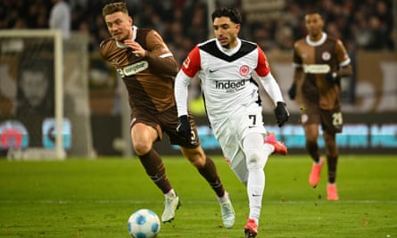 St Pauli’s Hauke Wahl, left and Frankfurt’s Omar Marmoush vie for the ball