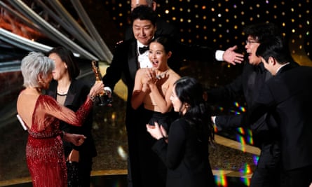 people in formal wear celebrate on stage