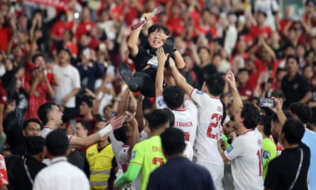 Indonesia head coach Shin Tae-yong is thrown into the air by his players during after their World Cup Asian second qualifier group game against the Philippines in June 2024.