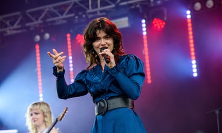 Abigail Morris of The Last Dinner Party on stage in a blue dress