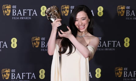 Mikey Madison with her leading actress award.