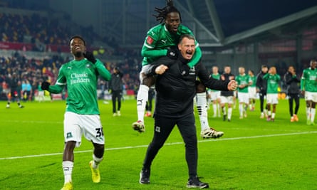 Kevin Nancekivell, Plymouth’s first-team coach, celebrates beating Brentford in the FA Cup third round with Darko Gyabi and Michael Baidoo