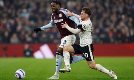 Aston Villa’s Axel Disasi holds off Alexis Mac Allister of Liverpool.