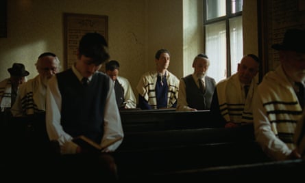 He sits in the synagogue in a prayer shawl