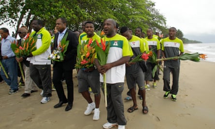 Kalusha Bwalya (centre) leads Zambia’s players as they carry flowers in Gabon to honour the 1993 team.