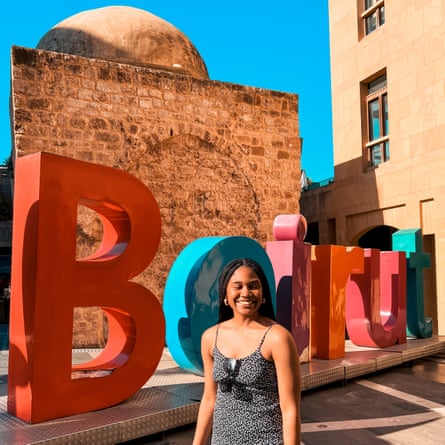 Alma Asinobi in front of letters reading Beirut in the sun.