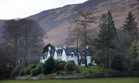 White buildings with grey roofs against the backdrop of a mountain