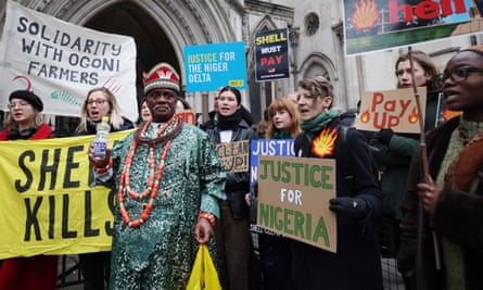 King Okpabi holds up a bottle of polluted water outside the high court in London.