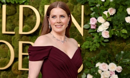 woman wearing maroon dress smiles