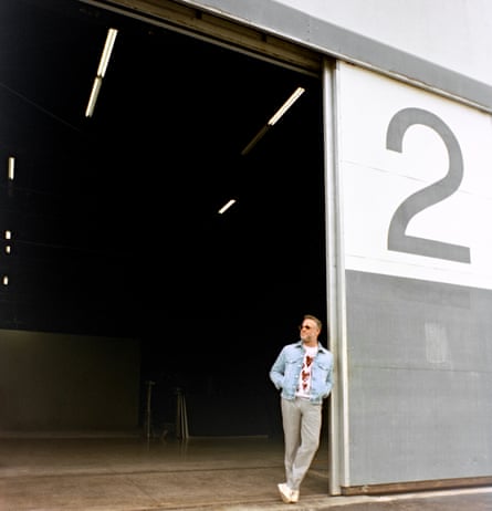 Actor Seth Rogen leaning against the door of a hangar