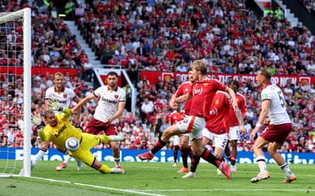 West Ham’s Alphonse Areola makes a diving save from Manchester United’s Rasmus Højlund.