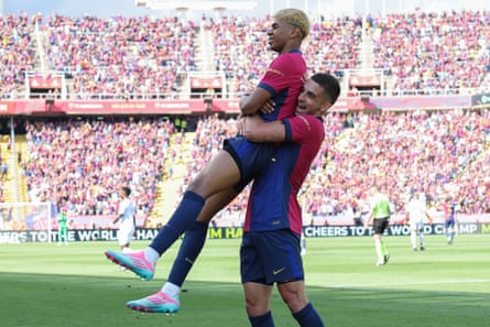Lamine Yamal if lifted by teammate Ferran Torres after scoring Barcelona’s second goal.